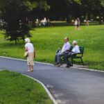 older adult woman wandering through park