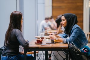 Two Women Talking at a Cafe