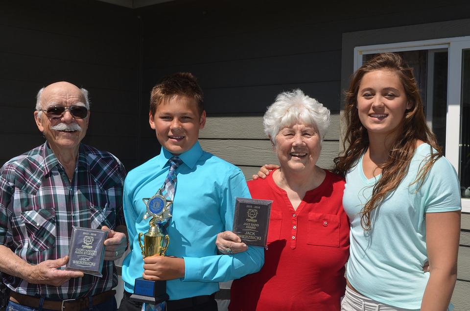 Grandparents and grandchildren holding trophies