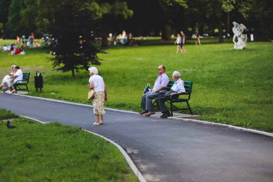 older adult woman wandering through park