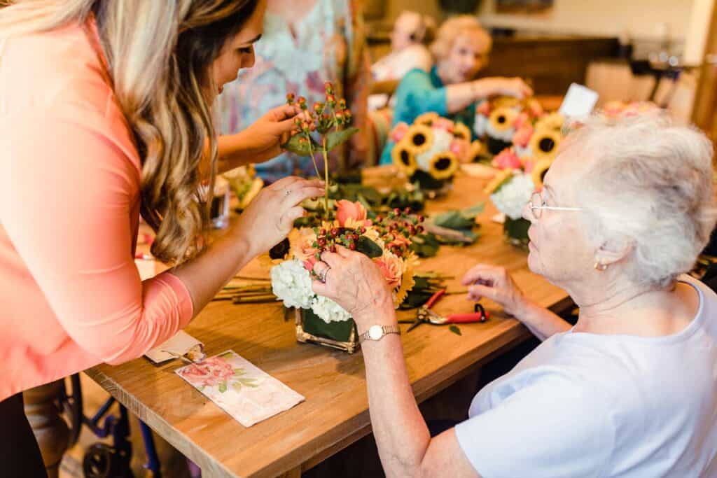 resident making floral arrangement