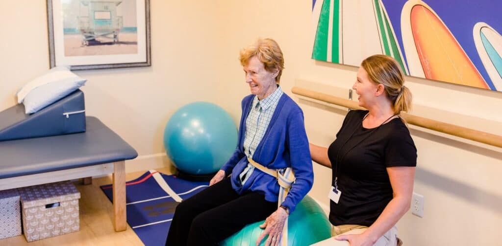 physical therapist working with elderly patient