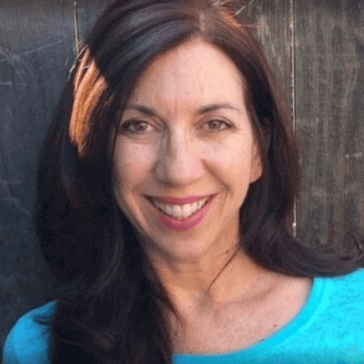 headshot of brunette in blue shirt