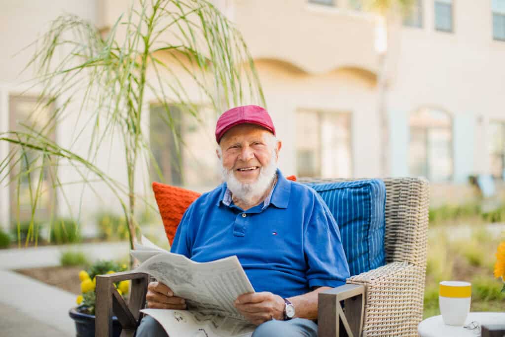 older man reading newspaper