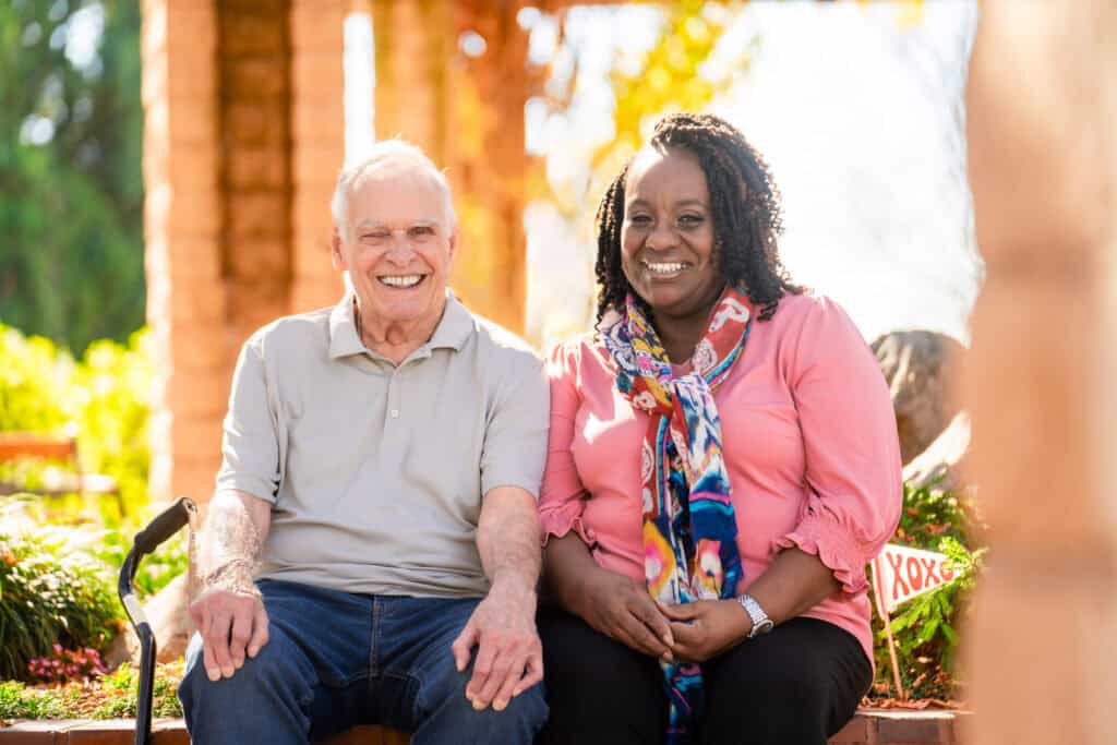 older man sitting with woman