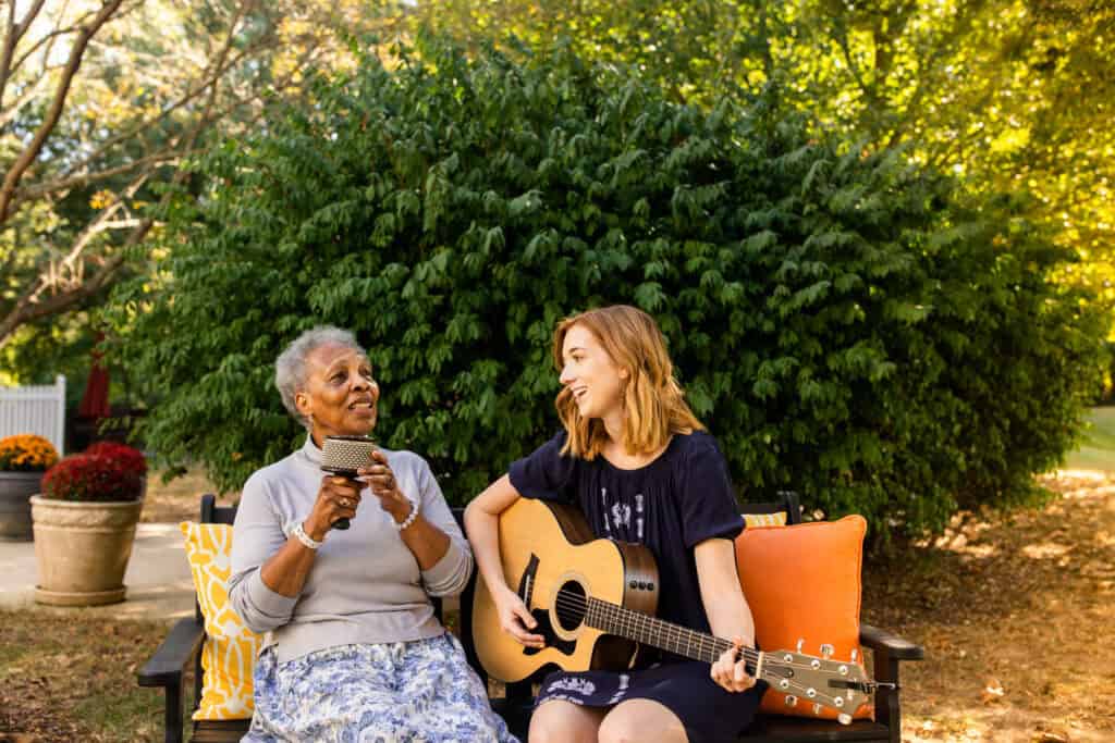 women singing and playing guitar